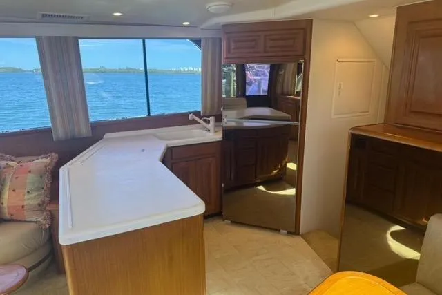  Yacht Photos Pics Interior of 1996 Viking 50 Sport Fisher yacht with kitchen and ocean view.