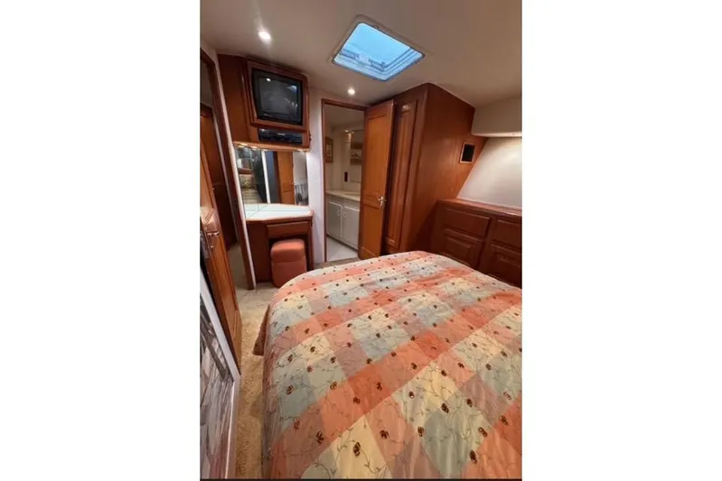 Yacht Photos Pics Interior of 1996 Viking 50 Sport Fisher yacht with cozy bedroom and TV.