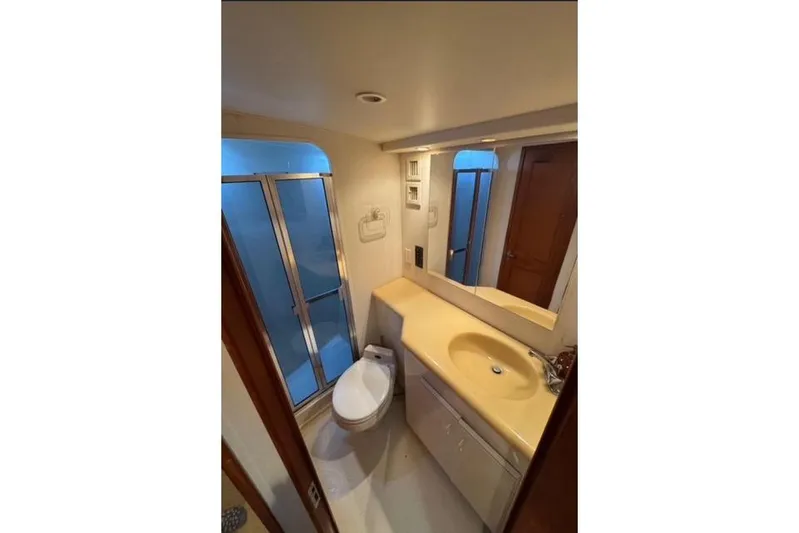  Yacht Photos Pics Bathroom interior of 1996 Viking 50 Sport Fisher Convertible yacht, featuring shower and vanity.