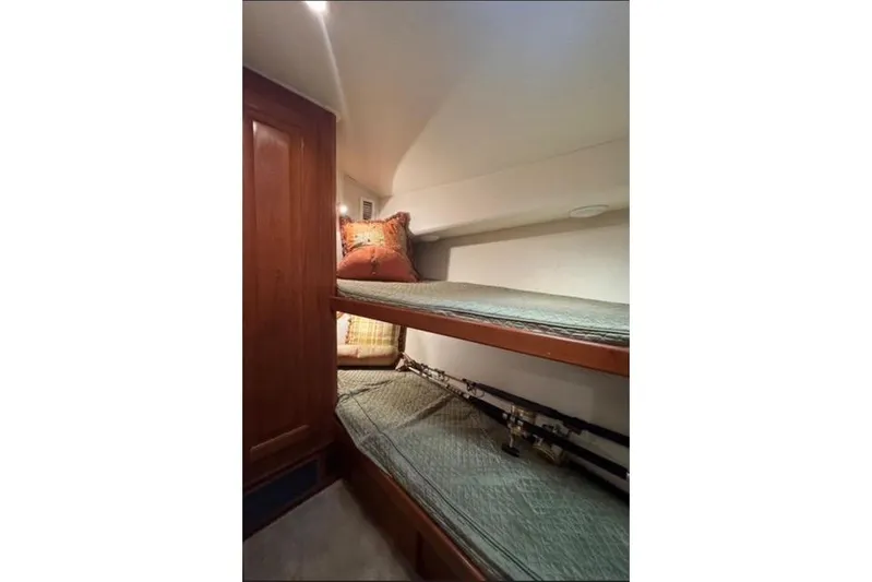  Yacht Photos Pics 1996 Viking 50 Sport Fisher Convertible cabin with bunk beds and fishing rods.