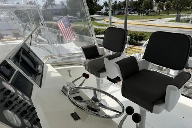  Yacht Photos Pics 1996 Viking 50 Sport Fisher Convertible helm with dual seats and steering wheel.