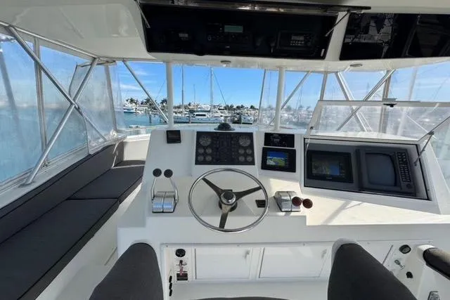  Yacht Photos Pics 1996 Viking 50 Sport Fisher Convertible helm with navigation equipment and marina view.