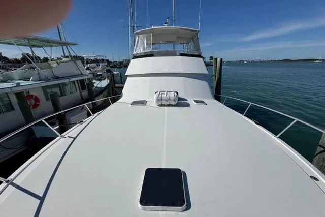  Yacht Photos Pics 1996 Viking 50 Sport Fisher Convertible yacht docked at marina, clear blue sky.