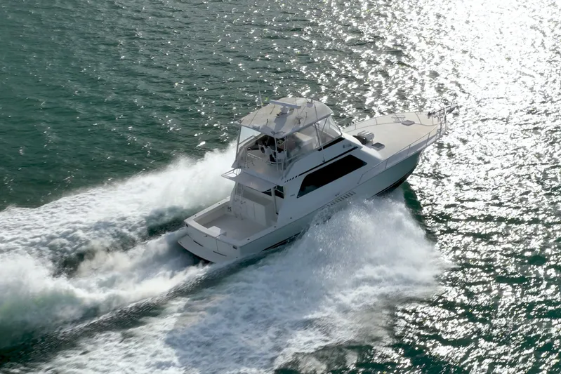  Yacht Photos Pics 1996 Viking 50 Sport Fisher Convertible cruising on sparkling water.