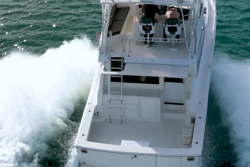  Yacht Photos Pics 1996 Viking 50 Sport Fisher Convertible cruising on open water, rear view.