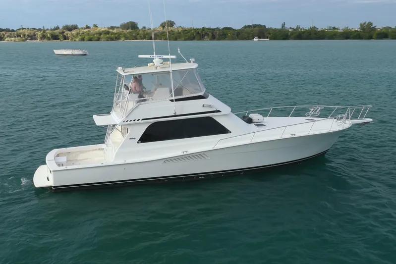  Yacht Photos Pics 1996 Viking 50 Sport Fisher Convertible yacht cruising on calm blue waters.