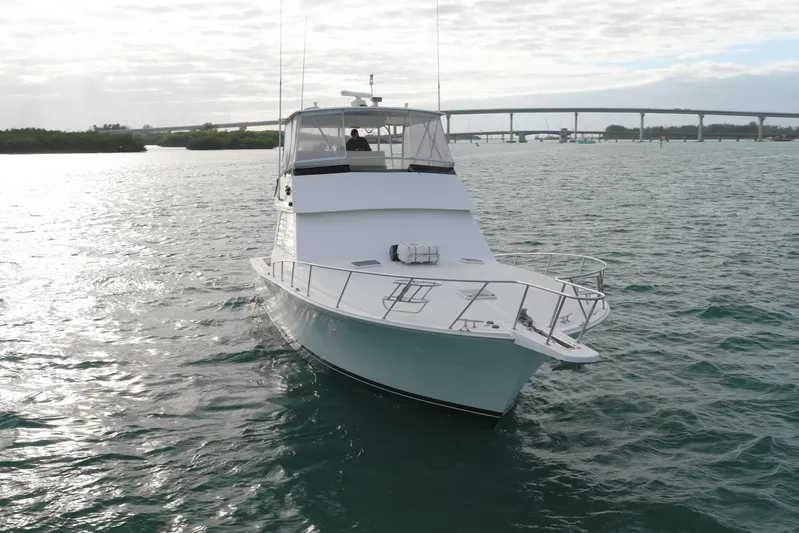  Yacht Photos Pics 1996 Viking 50 Sport Fisher Convertible yacht on open water, bridge in background.