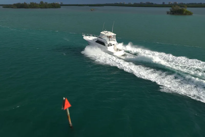  Yacht Photos Pics A 1996 Viking 50 Sport Fisher cruising swiftly on open water.