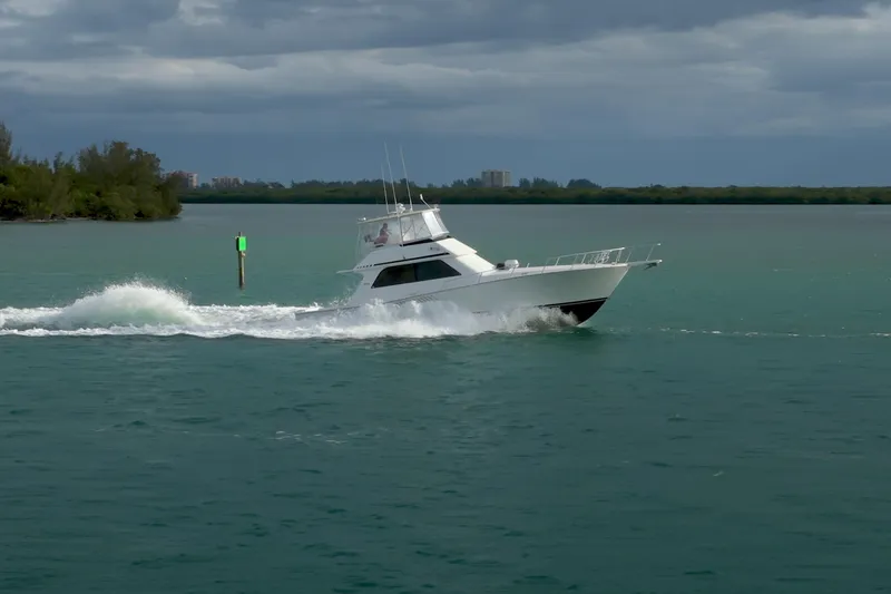  Yacht Photos Pics 1996 Viking 50 Sport Fisher Convertible cruising on open water under cloudy skies.
