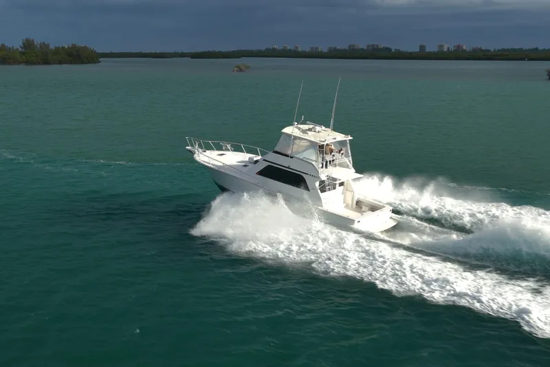  Yacht Photos Pics 1996 Viking 50 Sport Fisher Convertible cruising on open water, creating a dynamic wake.