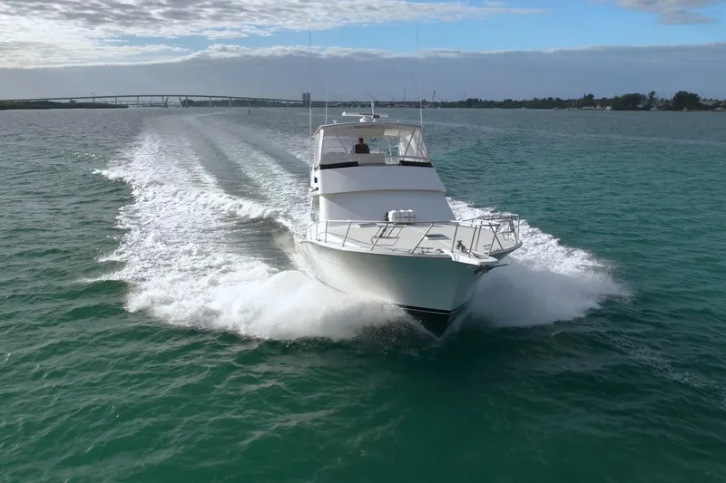  Yacht Photos Pics 1996 Viking 50 Sport Fisher Convertible cruising on open water under a cloudy sky.