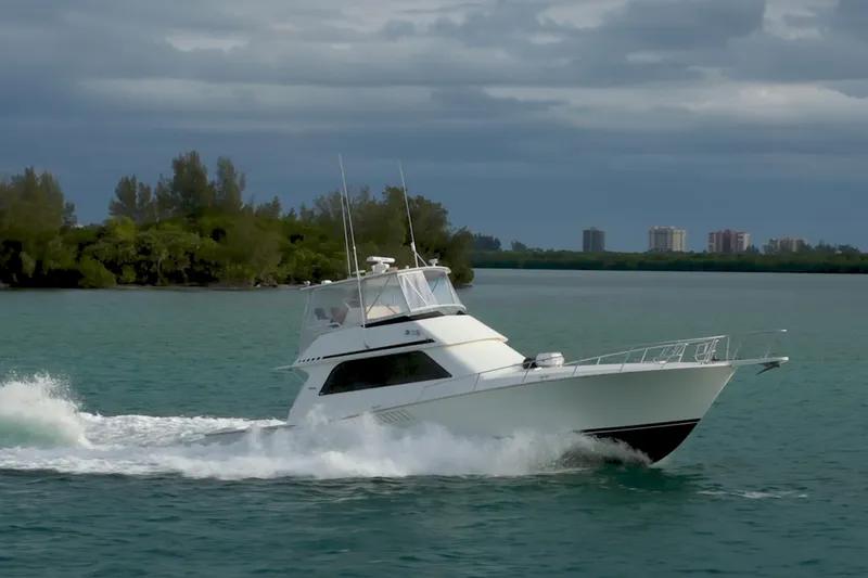  Yacht Photos Pics 1996 Viking 50 Sport Fisher Convertible cruising on a scenic waterway.
