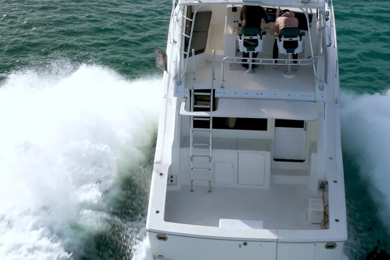  Yacht Photos Pics 1996 Viking 50 Sport Fisher Convertible cruising on open water, rear view.