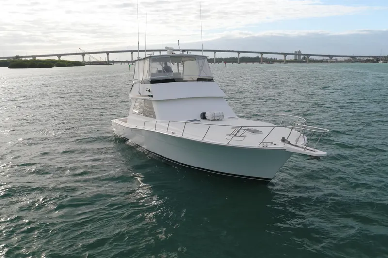  Yacht Photos Pics 1996 Viking 50 Sport Fisher Convertible yacht on open water near a bridge.
