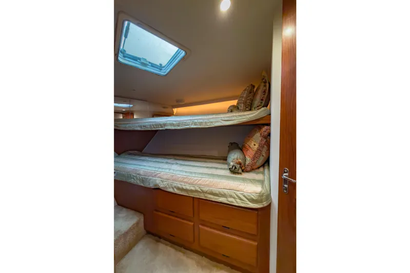  Yacht Photos Pics Bunk beds in 1996 Viking 50 Sport Fisher yacht cabin with skylight and storage drawers.