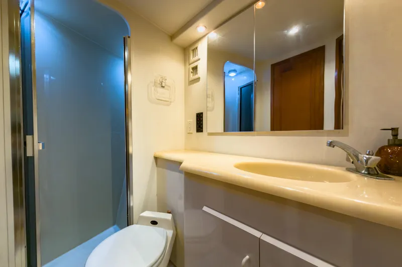  Yacht Photos Pics Bathroom interior of 1996 Viking 50 Sport Fisher Convertible yacht, featuring shower and sink.