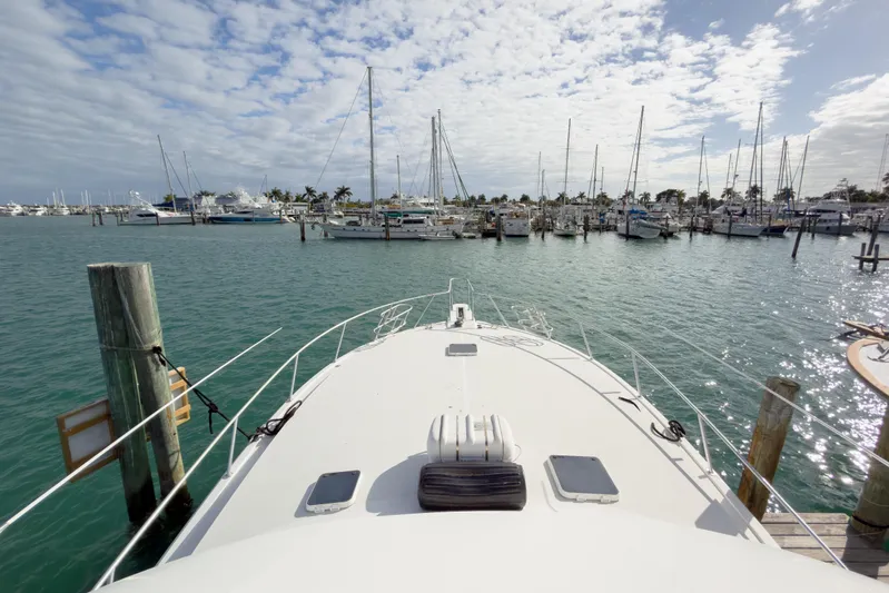  Yacht Photos Pics Bow view of 1996 Viking 50 Sport Fisher Convertible docked at marina under cloudy sky.