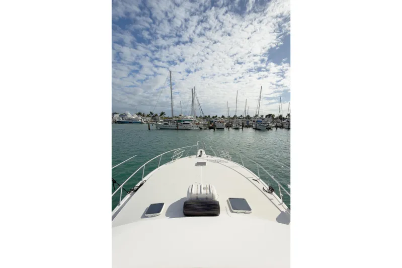  Yacht Photos Pics Bow view of 1996 Viking 50 Sport Fisher Convertible at marina under cloudy sky.