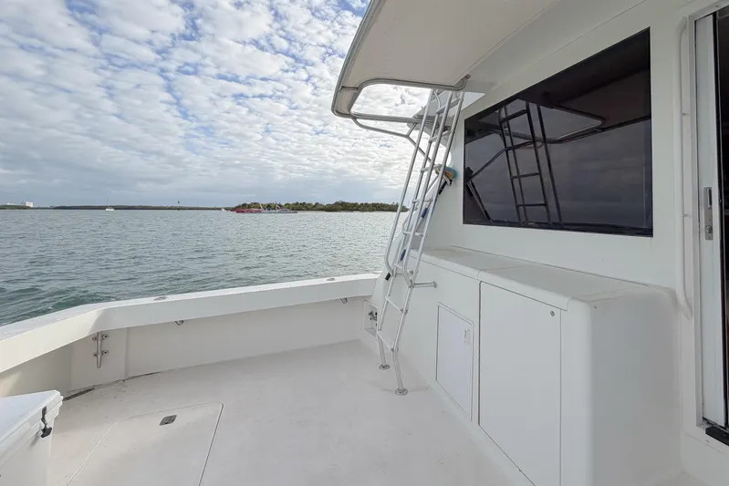  Yacht Photos Pics 1996 Viking 50 Sport Fisher Convertible boat deck with ocean view and ladder.