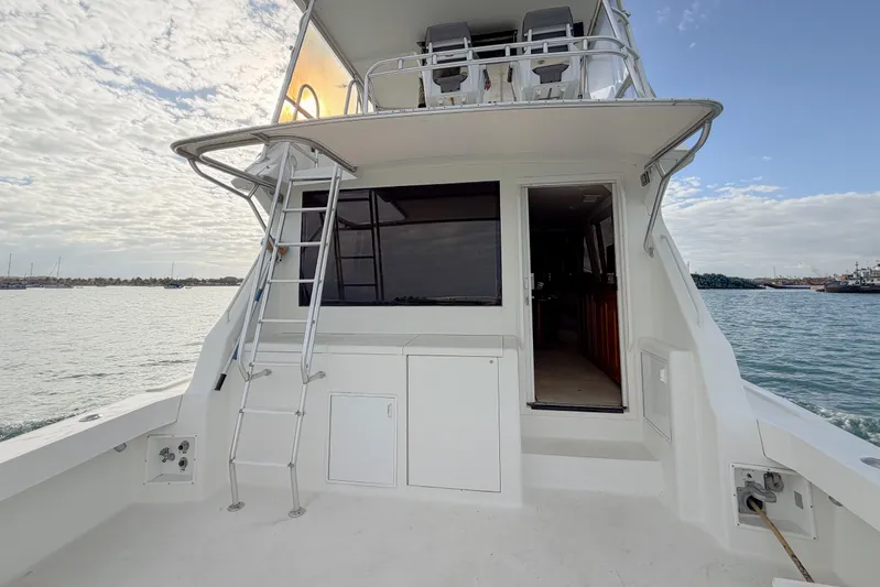  Yacht Photos Pics 1996 Viking 50 Sport Fisher Convertible boat with ladder and open cabin door.