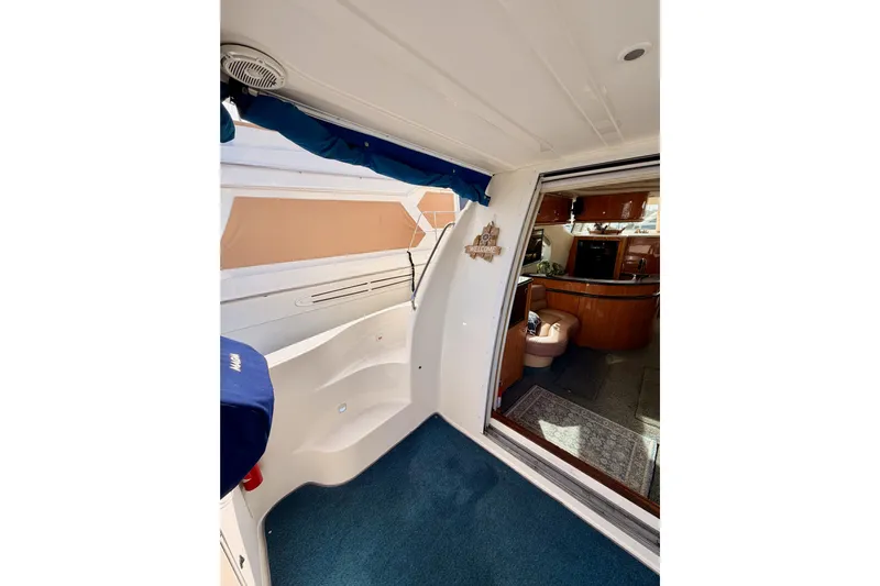 Spirit Of St Louis Yacht Photos Pics 2001 Maxum 4600 SCB Limited Edition yacht interior with blue carpet and wooden cabinetry.
