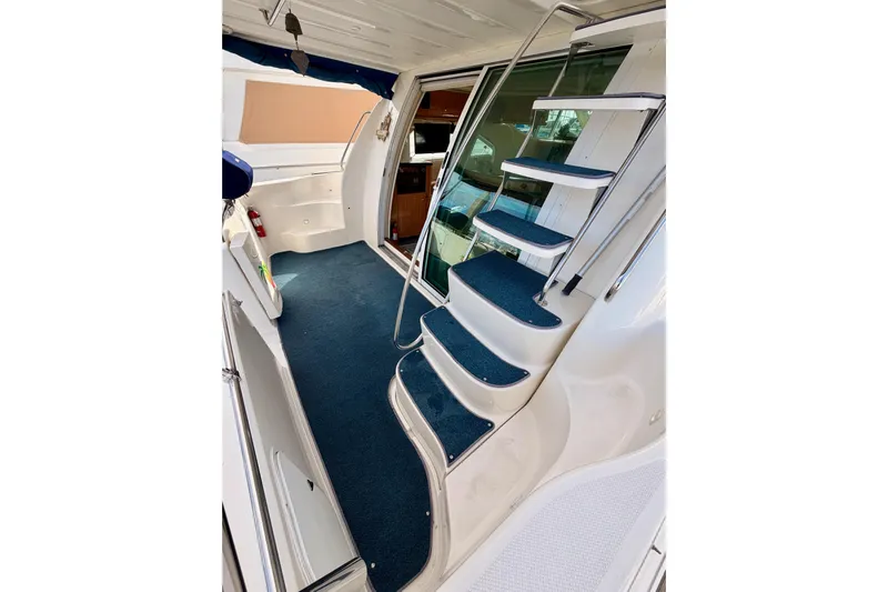 Spirit Of St Louis Yacht Photos Pics Interior view of 2001 Maxum 4600 SCB Limited Edition yacht with blue-carpeted stairs.