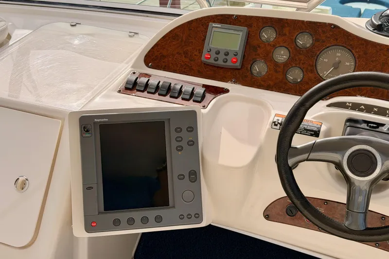 Spirit Of St Louis Yacht Photos Pics Control panel of 2001 Maxum 4600 SCB Limited Edition yacht with steering wheel and navigation display.