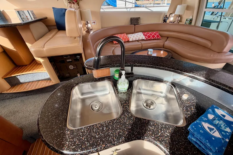 Spirit Of St Louis Yacht Photos Pics Luxurious interior of 2001 Maxum 4600 SCB yacht with modern kitchen and seating area.