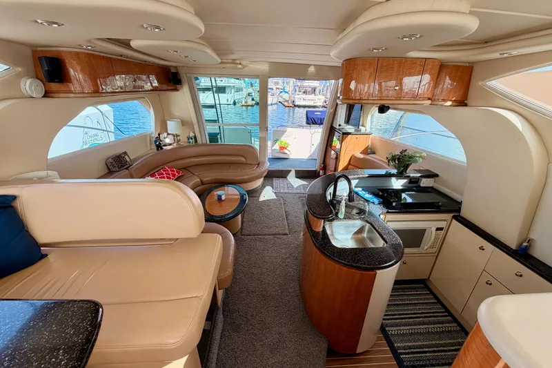 Spirit Of St Louis Yacht Photos Pics Luxurious interior of 2001 Maxum 4600 SCB yacht with modern kitchen and seating area.