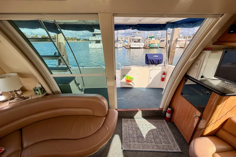 Spirit Of St Louis Yacht Photos Pics Interior view of 2001 Maxum 4600 SCB yacht, featuring luxurious seating and marina backdrop.