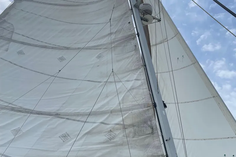 Endless Summer Yacht Photos Pics Sails of a 2008 Admiral 40 Executive yacht against a blue sky.