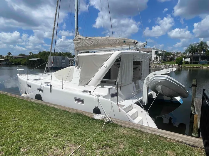 Endless Summer Yacht Photos Pics 2008 Admiral Executive catamaran docked by a scenic waterfront under a blue sky.
