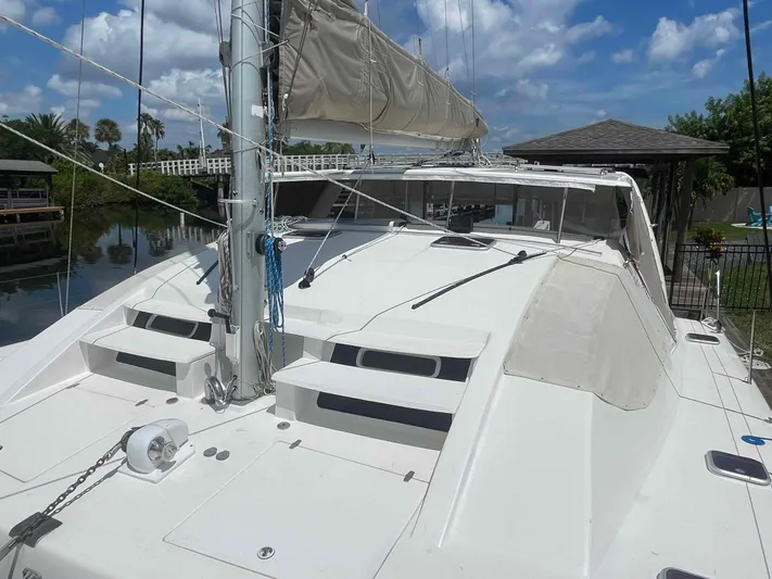 Endless Summer Yacht Photos Pics 2008 Admiral Executive sailboat docked by a scenic waterfront under a blue sky.