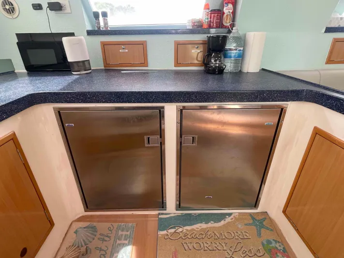 Endless Summer Yacht Photos Pics Modern kitchen area in a 2008 Admiral Executive yacht with stainless steel appliances.