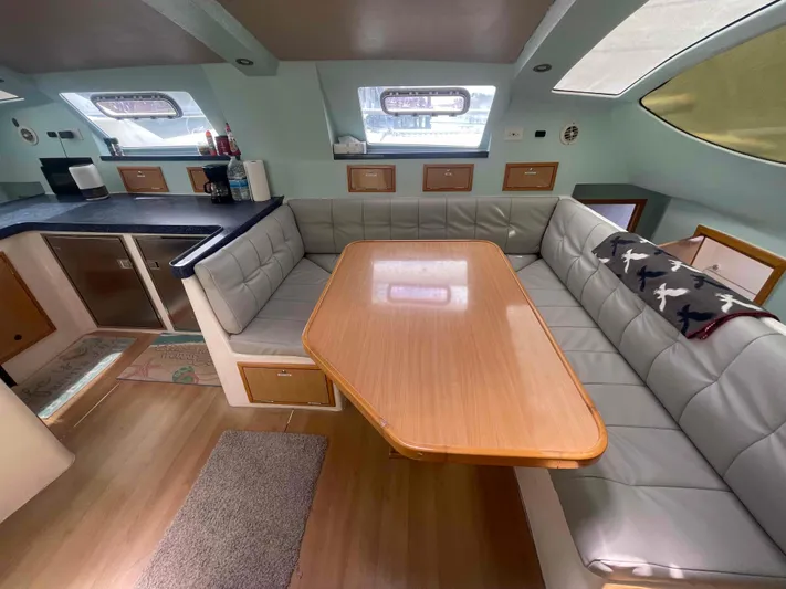 Endless Summer Yacht Photos Pics Interior of 2008 Admiral Executive yacht with cozy seating and dining area.