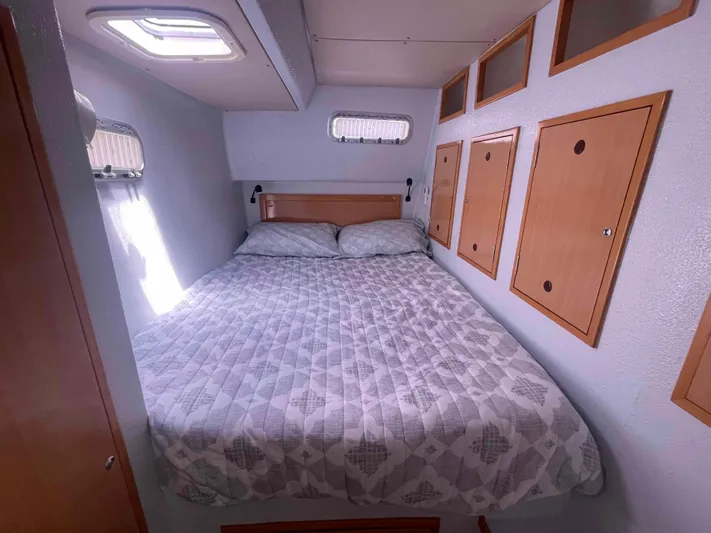 Endless Summer Yacht Photos Pics Cozy bedroom in 2008 Admiral Executive boat with storage cabinets and natural light.