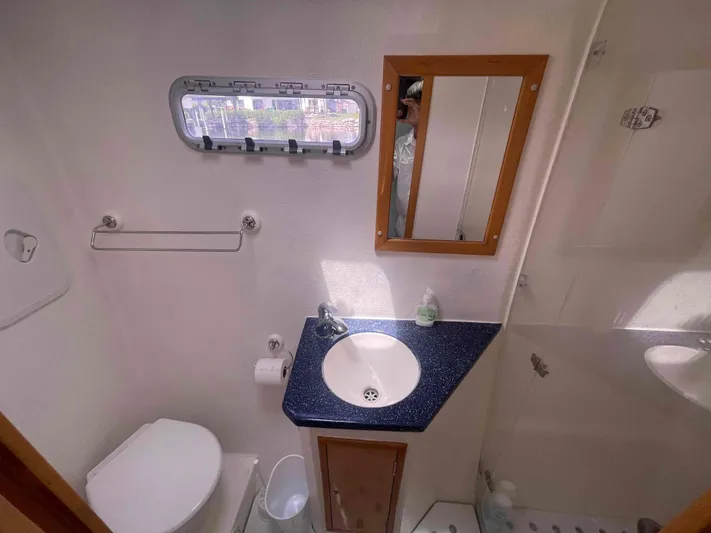 Endless Summer Yacht Photos Pics Compact bathroom in 2008 Admiral Executive boat with sink, toilet, and mirror.