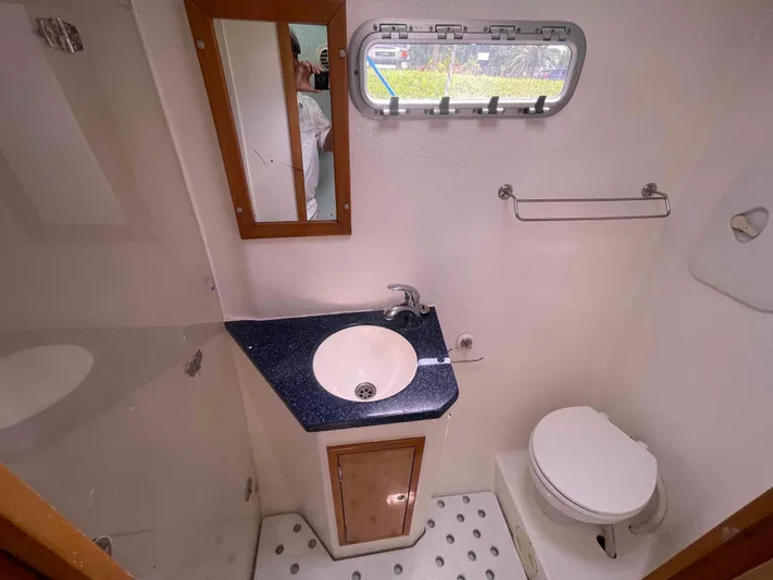 Endless Summer Yacht Photos Pics Compact bathroom in 2008 Admiral Executive boat with sink, toilet, and mirror.