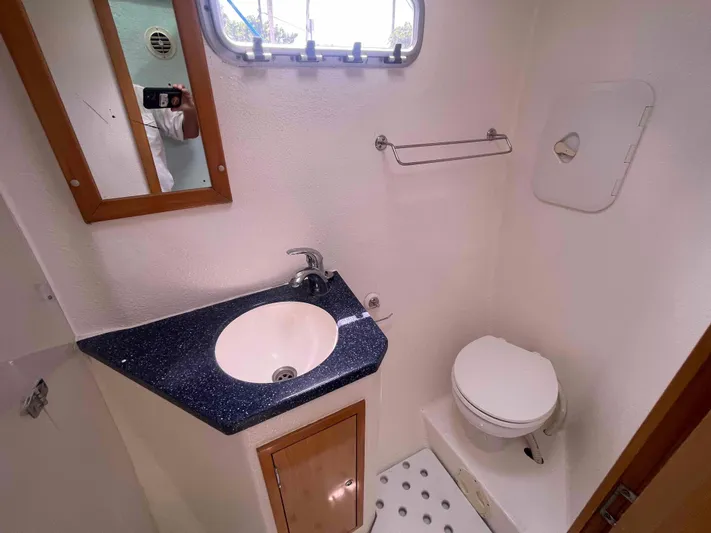 Endless Summer Yacht Photos Pics Compact bathroom in 2008 Admiral Executive boat with sink, mirror, and toilet.