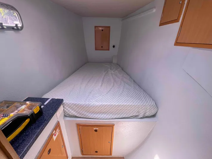 Endless Summer Yacht Photos Pics Compact cabin interior of 2008 Admiral Executive with bed and storage cabinets.