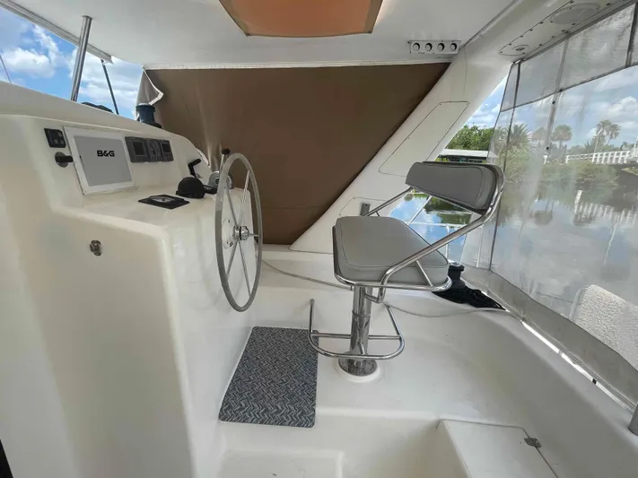 Endless Summer Yacht Photos Pics Helm station of 2008 Admiral Executive yacht with steering wheel and captain's chair.