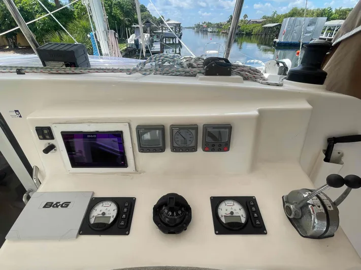 Endless Summer Yacht Photos Pics Control panel of a 2008 Admiral Executive boat with navigation instruments and throttle.