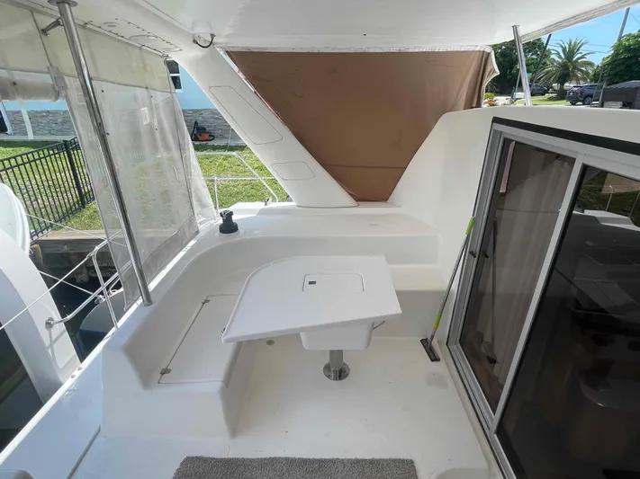 Endless Summer Yacht Photos Pics 2008 Admiral Executive yacht deck with seating area and sliding glass door.