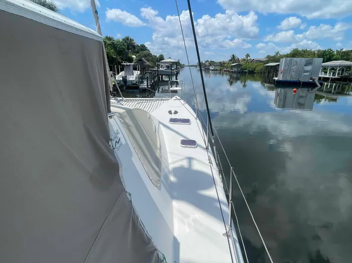 Endless Summer Yacht Photos Pics 2008 Admiral Executive yacht docked on a calm, reflective waterway under a blue sky.