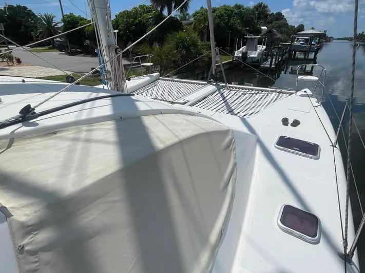 Endless Summer Yacht Photos Pics 2008 Admiral Executive yacht docked by a canal, featuring a spacious deck and lush surroundings.