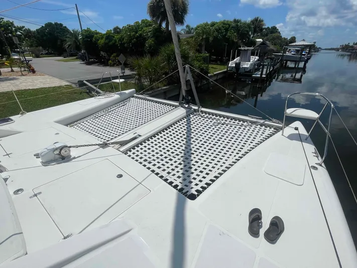 Endless Summer Yacht Photos Pics Catamaran deck with netting, docked by a canal, featuring Admiral Executive 2008 model.