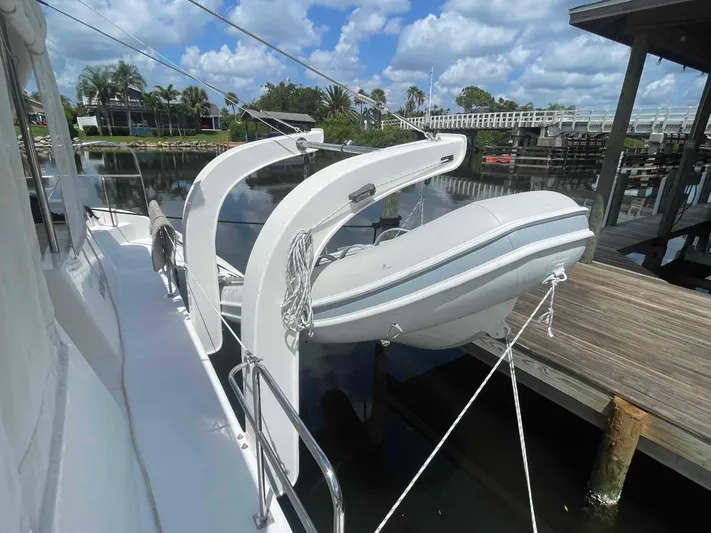 Endless Summer Yacht Photos Pics Luxury yacht Admiral Executive 2008 with dinghy, docked by a scenic waterfront.