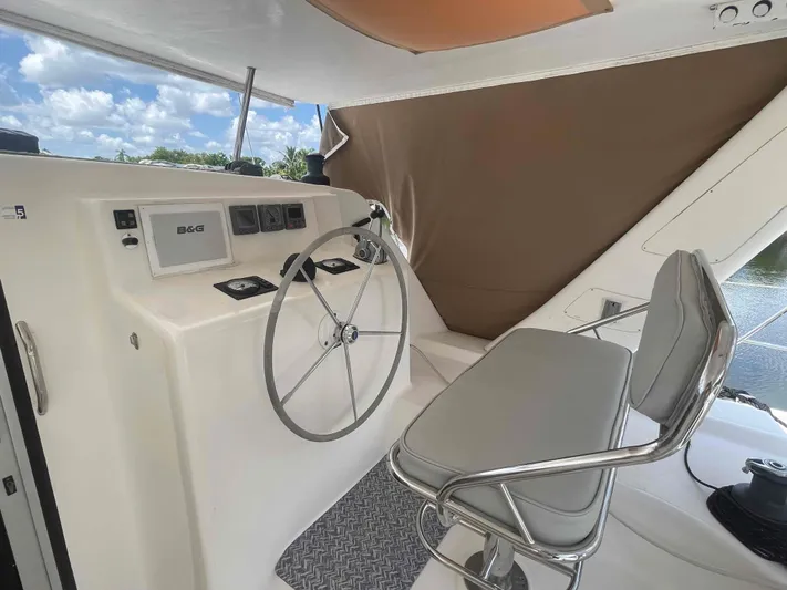 Endless Summer Yacht Photos Pics Helm of 2008 Admiral Executive yacht with steering wheel and navigation equipment.