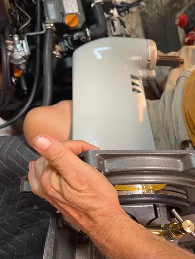 Endless Summer Yacht Photos Pics Person working on Admiral Executive engine, 2008 model, with visible components and tools.