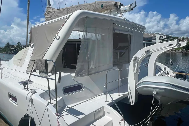 Endless Summer Yacht Photos Pics 2008 Admiral Executive yacht with canopy and dinghy, docked by the water under a blue sky.